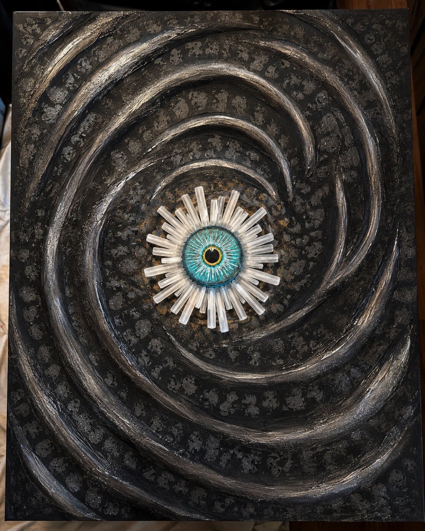 A dark spiral field with a turquoise eye at the center, ringed by rods of selenite.